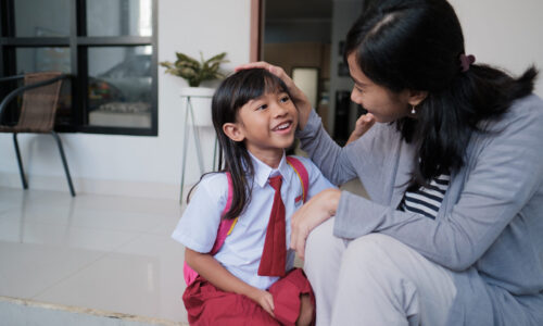 happy primary student at back home after school and talk happy primary student at back home after school and talk to her mother