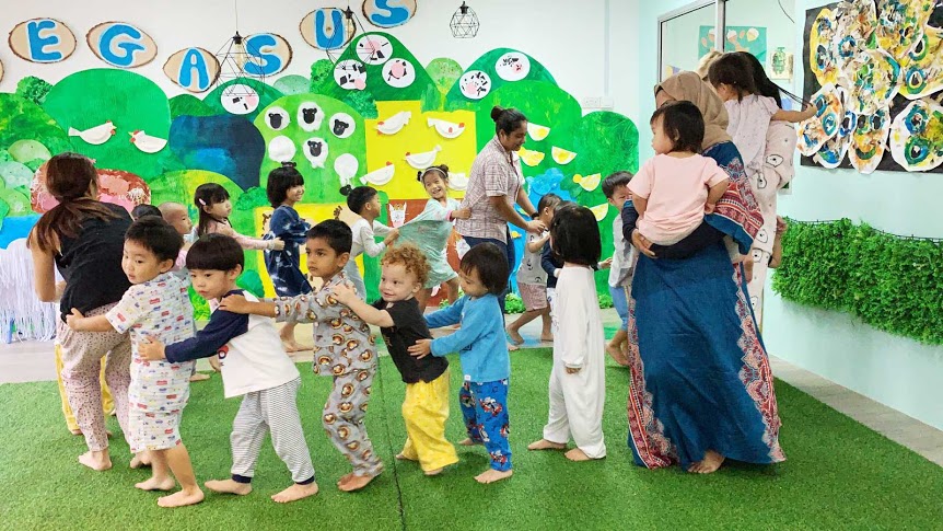 Pegasus preschool teacher and student playing indoors